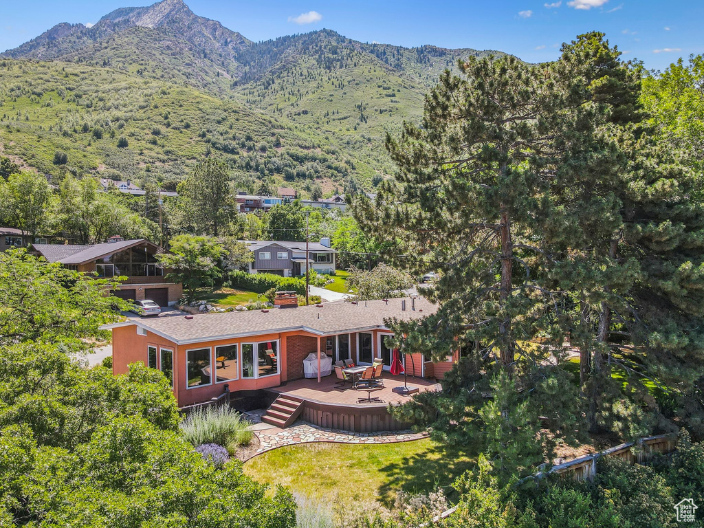 Aerial view of property and surrounding area featuring a mountain backdrop