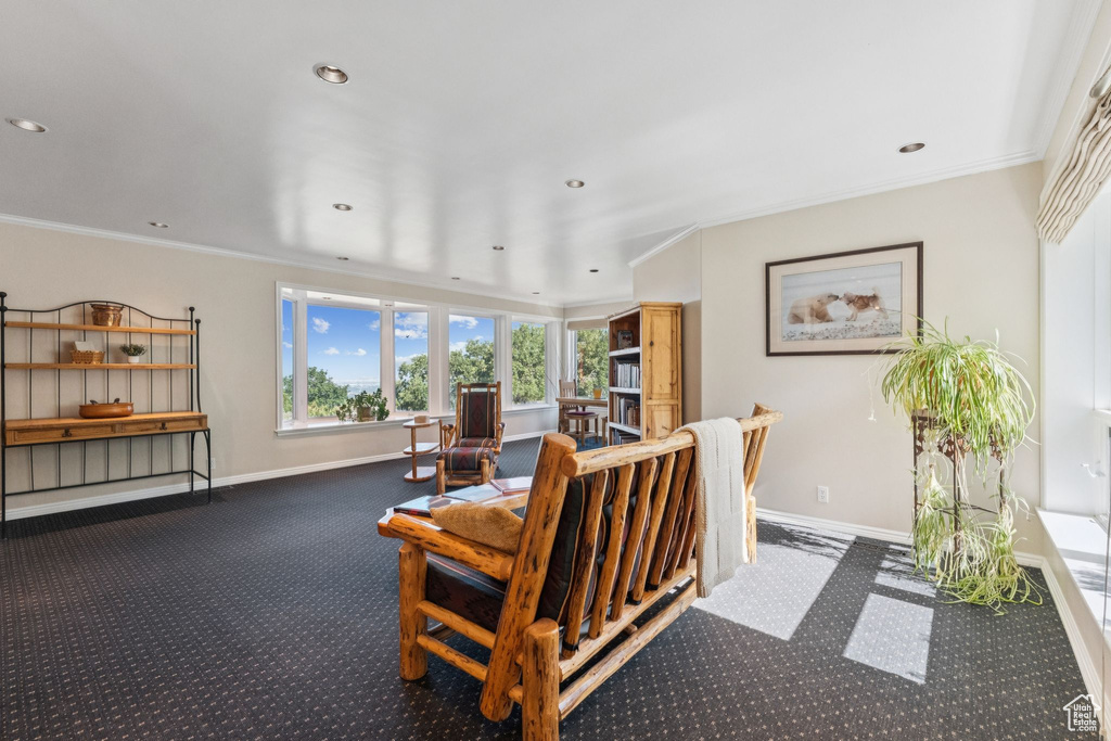 Living room with carpet floors, a fireplace, crown molding, and recessed lighting