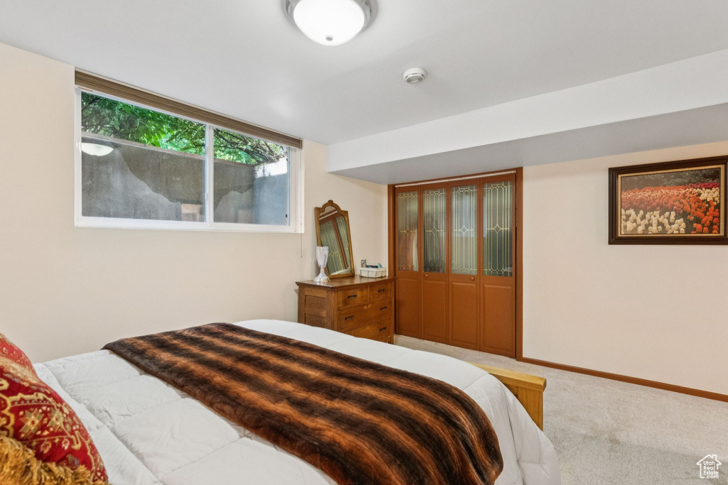 Bedroom featuring light colored carpet and baseboards