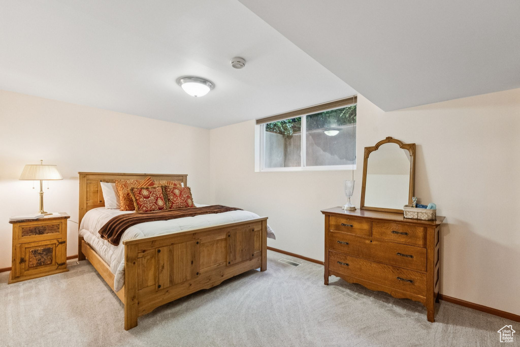 Bedroom featuring light colored carpet