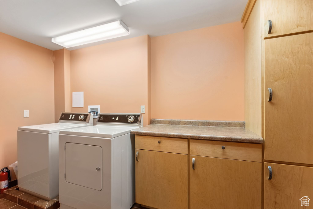 Laundry room featuring cabinet space and washer and clothes dryer