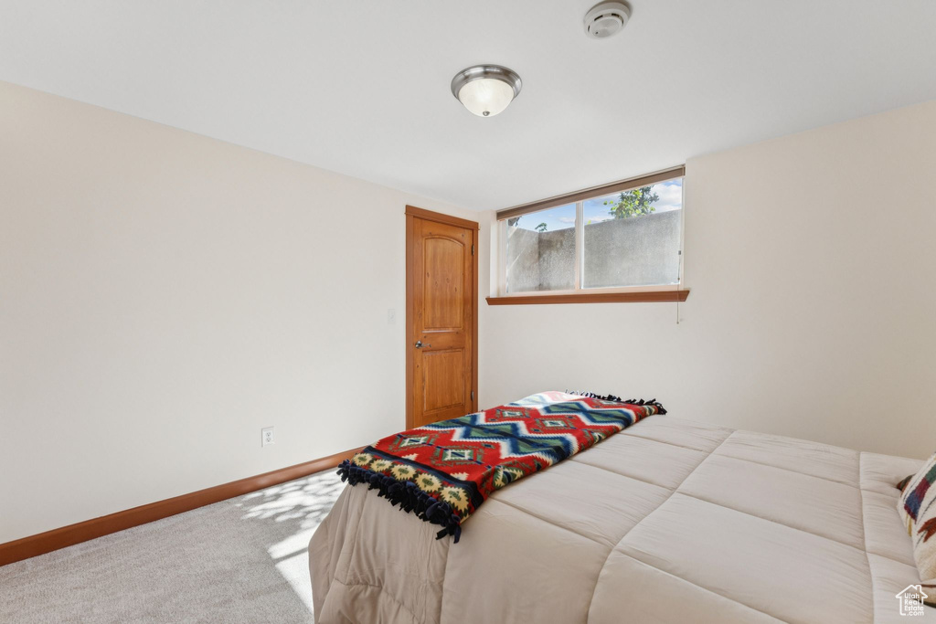 Carpeted bedroom with baseboards
