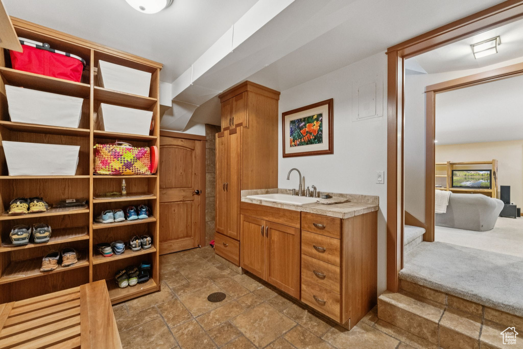 Bathroom featuring stone tile floors and vanity