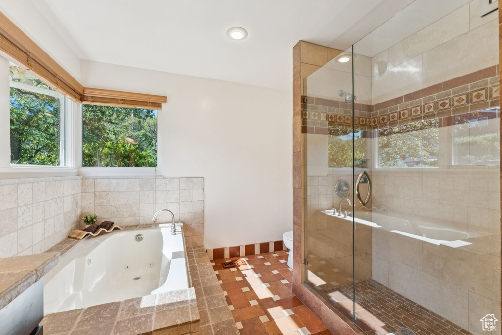 Full bath featuring a shower stall, a jetted tub, and recessed lighting