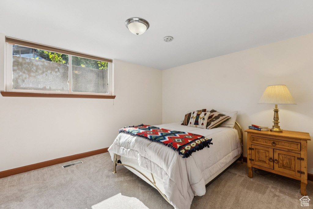 Carpeted bedroom featuring baseboards