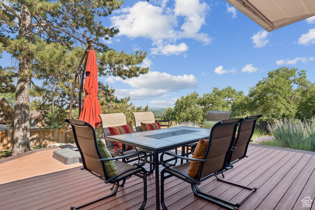 Wooden terrace featuring outdoor dining area