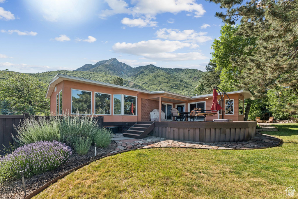 Rear view of property featuring a deck with mountain view