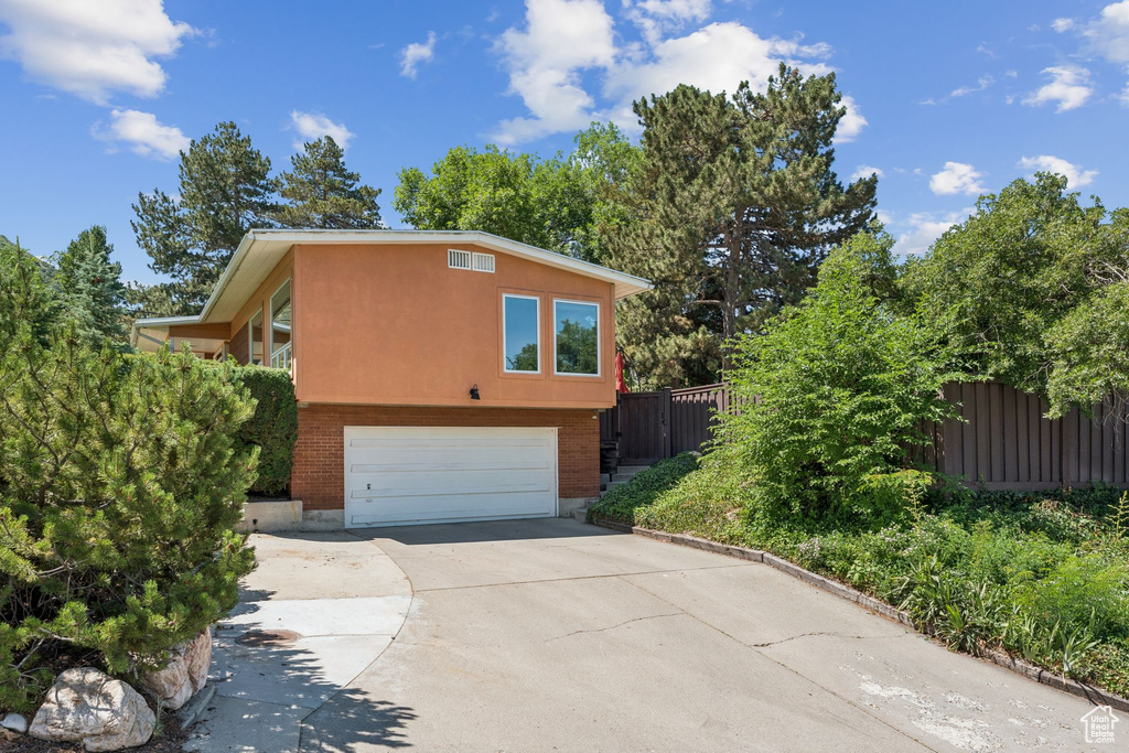 View of home's exterior featuring an attached garage and concrete driveway