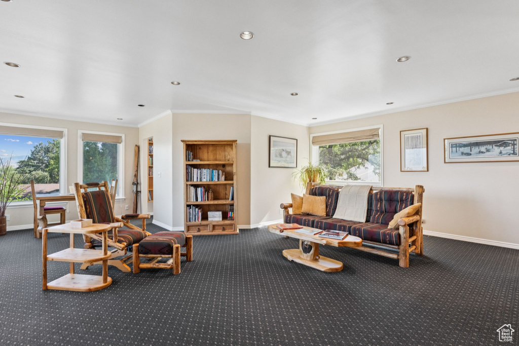 Carpeted living room with ornamental molding and recessed lighting