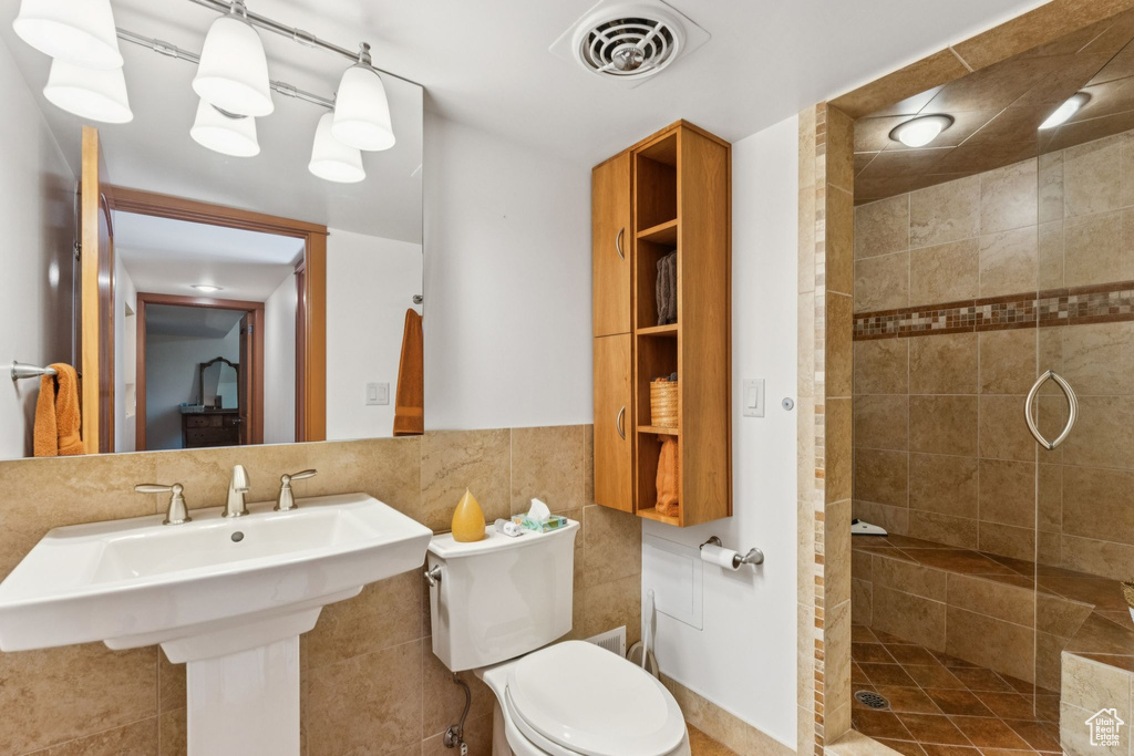 Full bathroom with a stall shower and toilet
