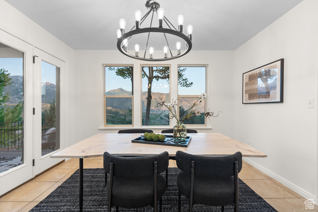Dining room featuring light tile patterned floors and a chandelier