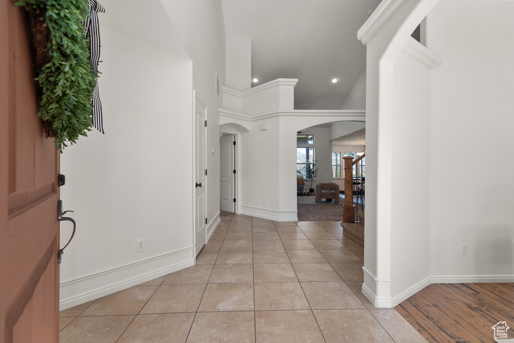 Foyer with arched walkways, recessed lighting, and light tile patterned flooring