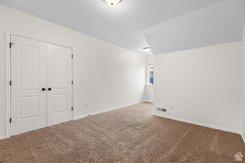 Additional living space featuring carpet and baseboards