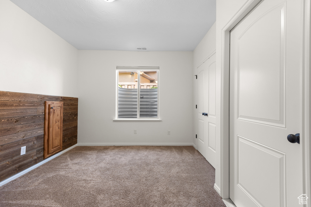 Unfurnished bedroom with carpet floors and a closet