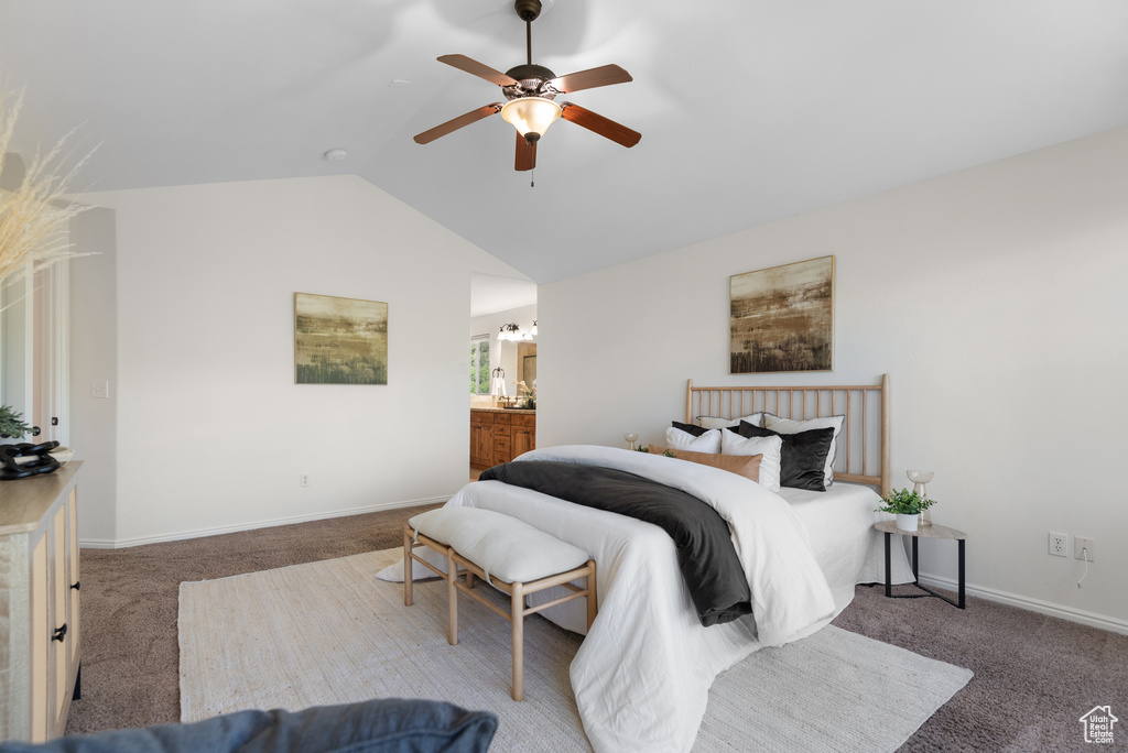 Bedroom with carpet floors, lofted ceiling, a ceiling fan, and connected bathroom