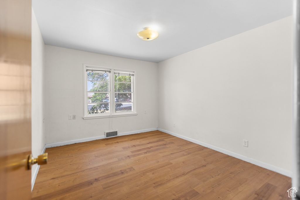 Spare room with light wood-style floors and baseboards