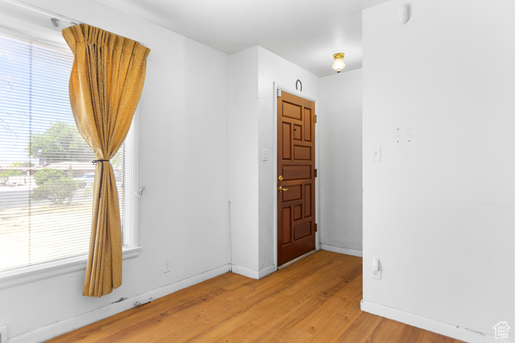 Unfurnished room with light wood-style flooring and baseboards