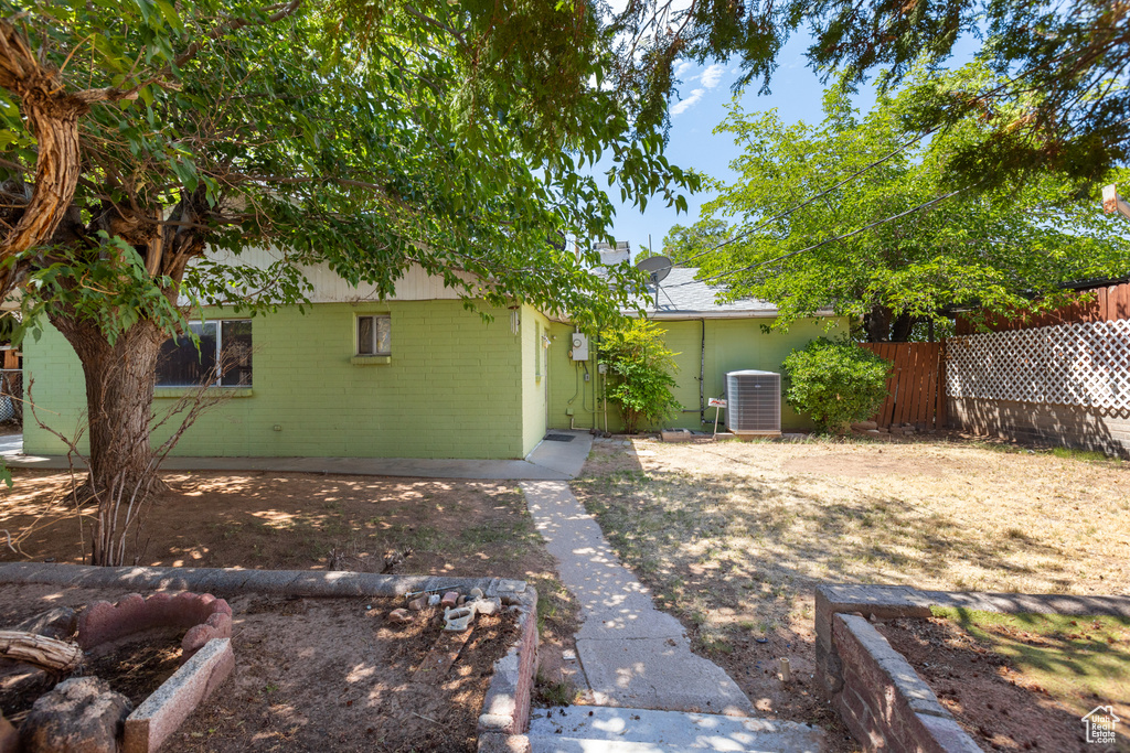 Back of house featuring concrete block siding