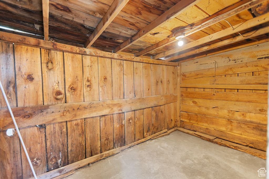 Below grade area featuring wood walls