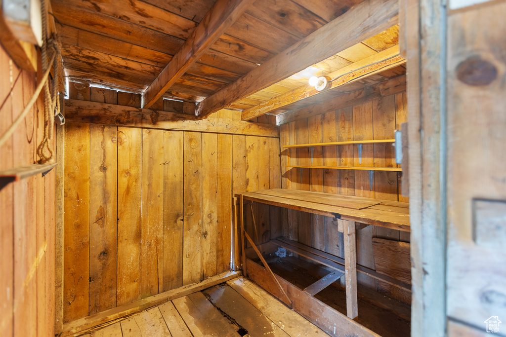 Relaxing sauna featuring wood ceiling, wood walls, and wood-type flooring