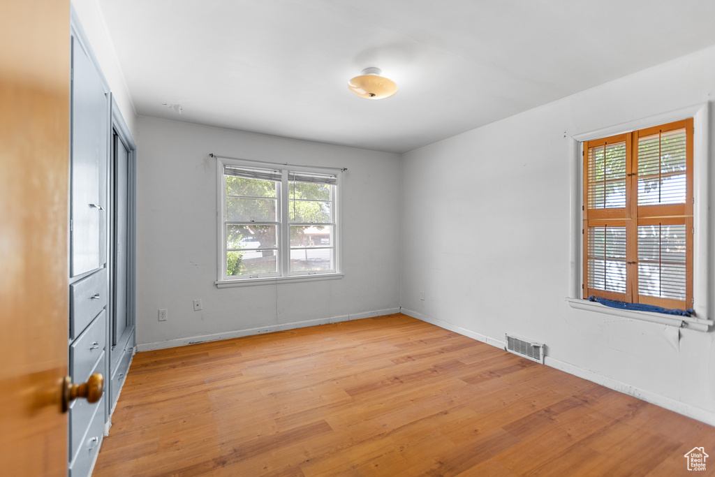 Spare room with light wood-type flooring and baseboards