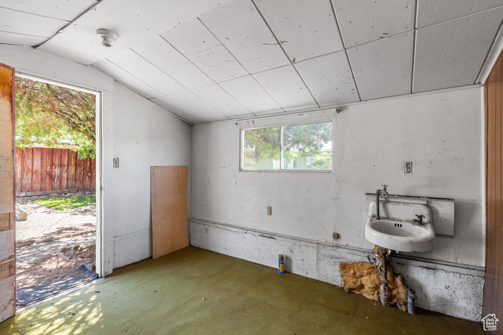 Interior space featuring lofted ceiling, concrete flooring, and a smoke detector