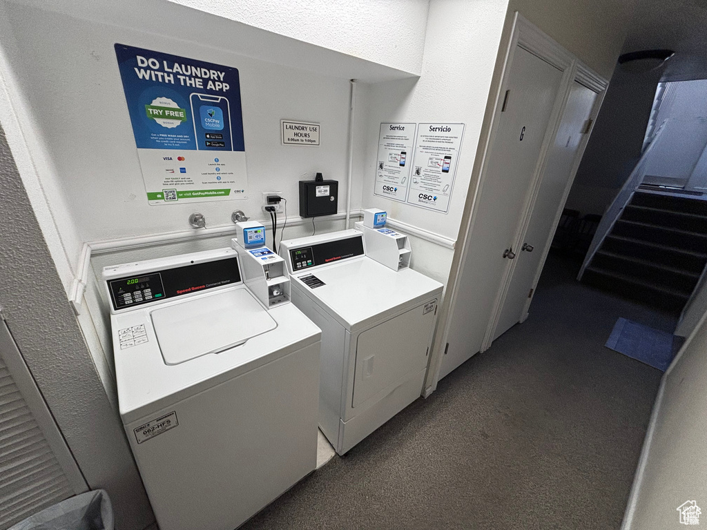 Community laundry room with washer and clothes dryer