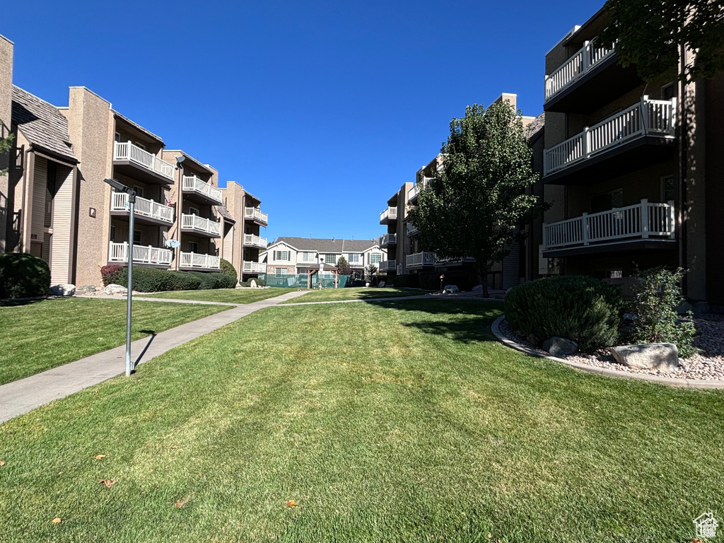 View of home's community with a yard