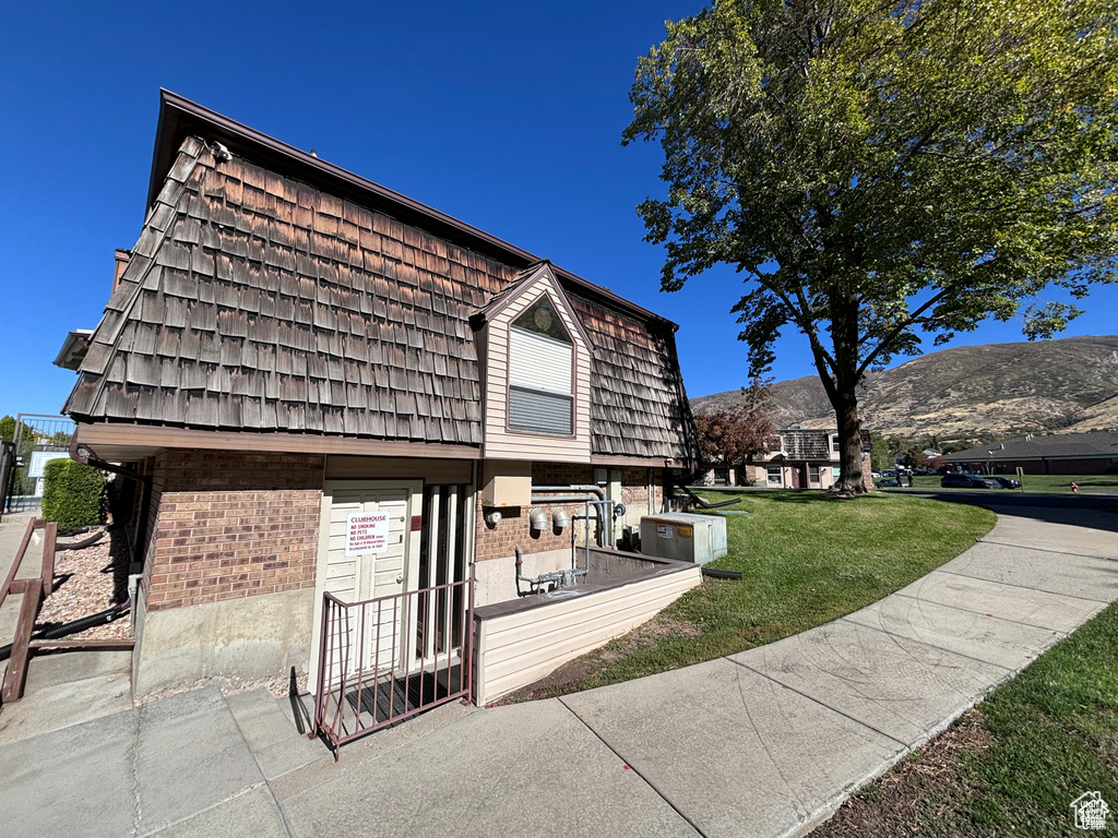 View of community featuring a mountain view and a yard