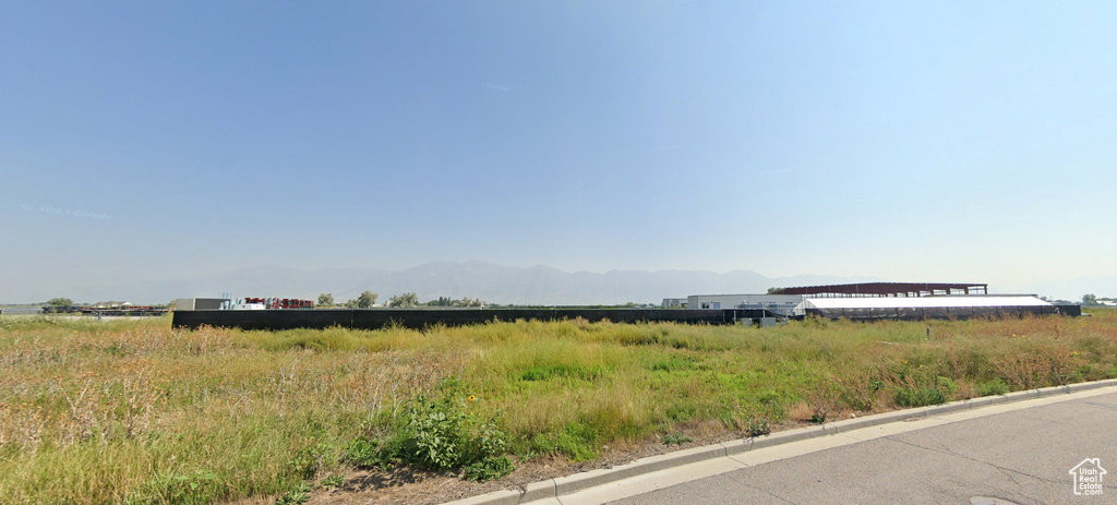 View of asphalt road with curbs and a mountain view
