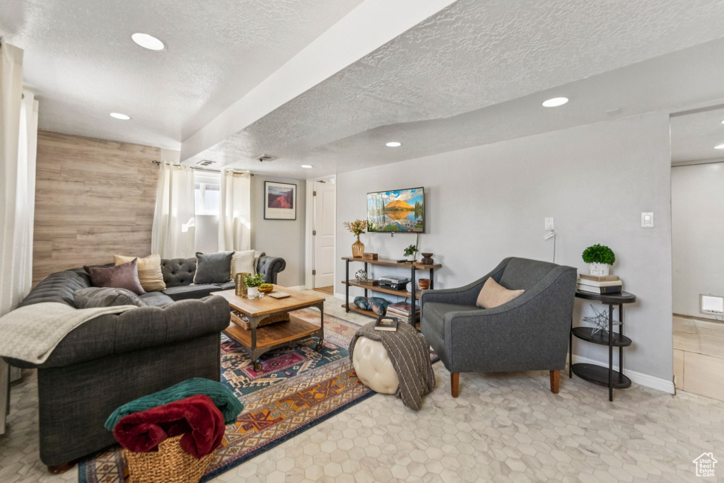 Living area with a textured ceiling and recessed lighting