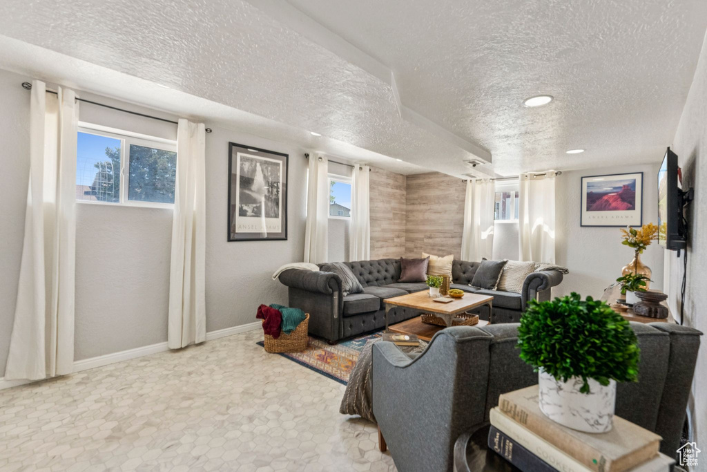 Living area featuring a textured ceiling, plenty of natural light, and recessed lighting