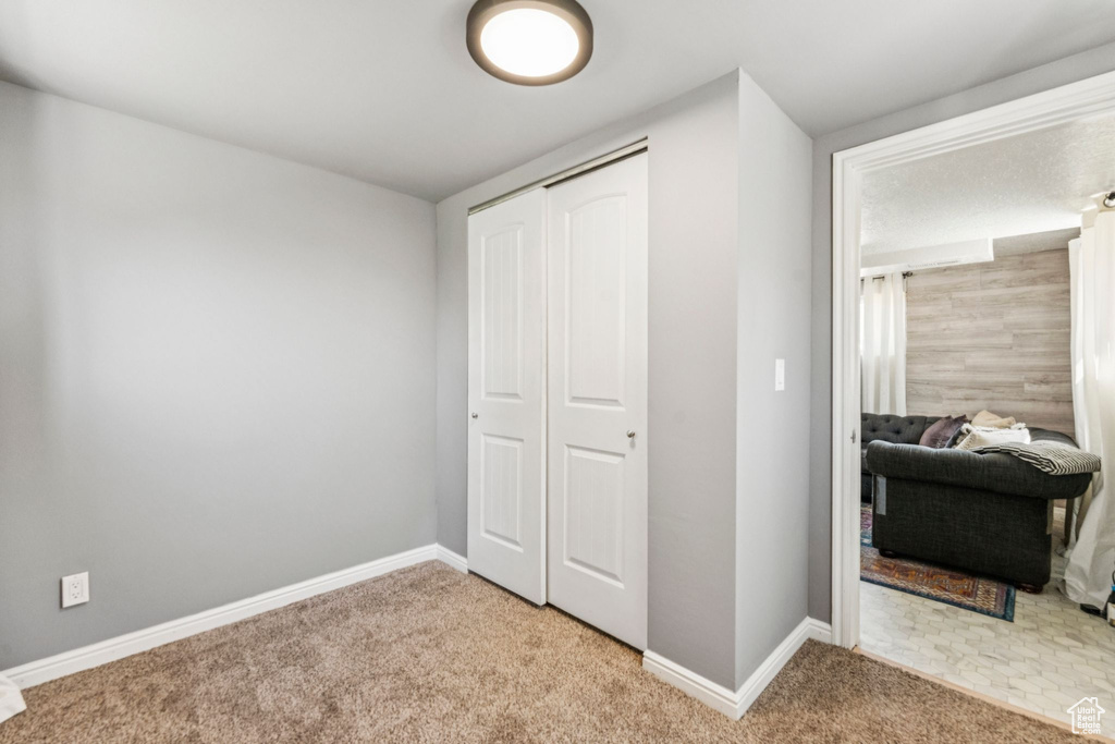 Bedroom with carpet and a closet