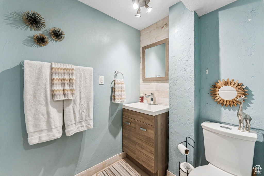 Half bath with vanity and toilet
