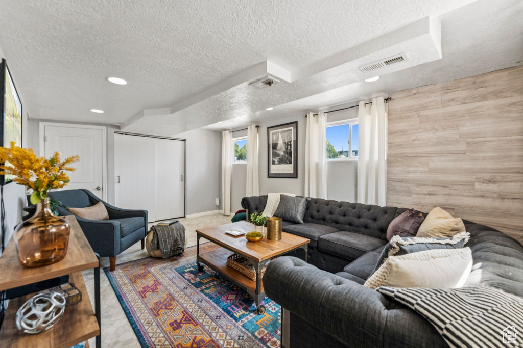 Living room featuring a textured ceiling and recessed lighting