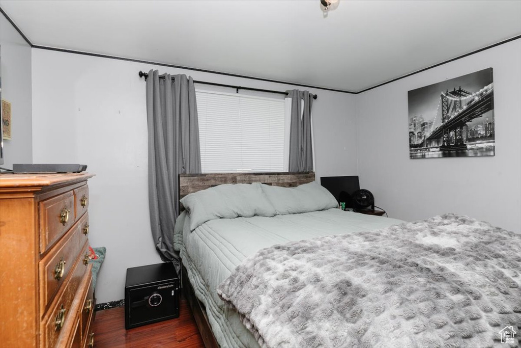 Bedroom with dark wood-style floors