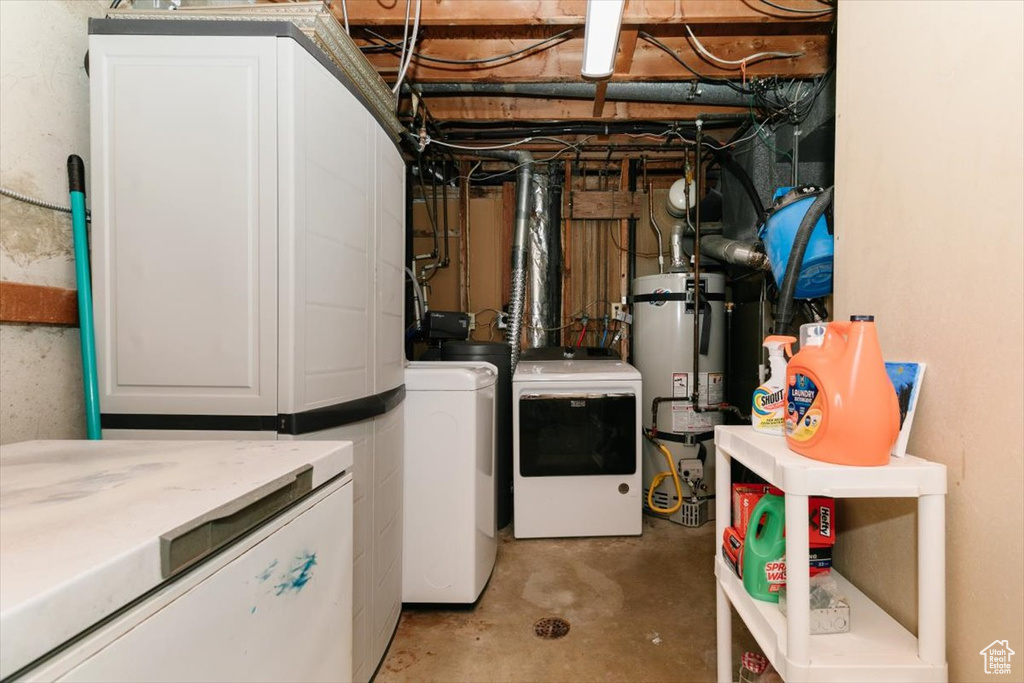 Below grade area featuring separate washer and dryer and secured water heater