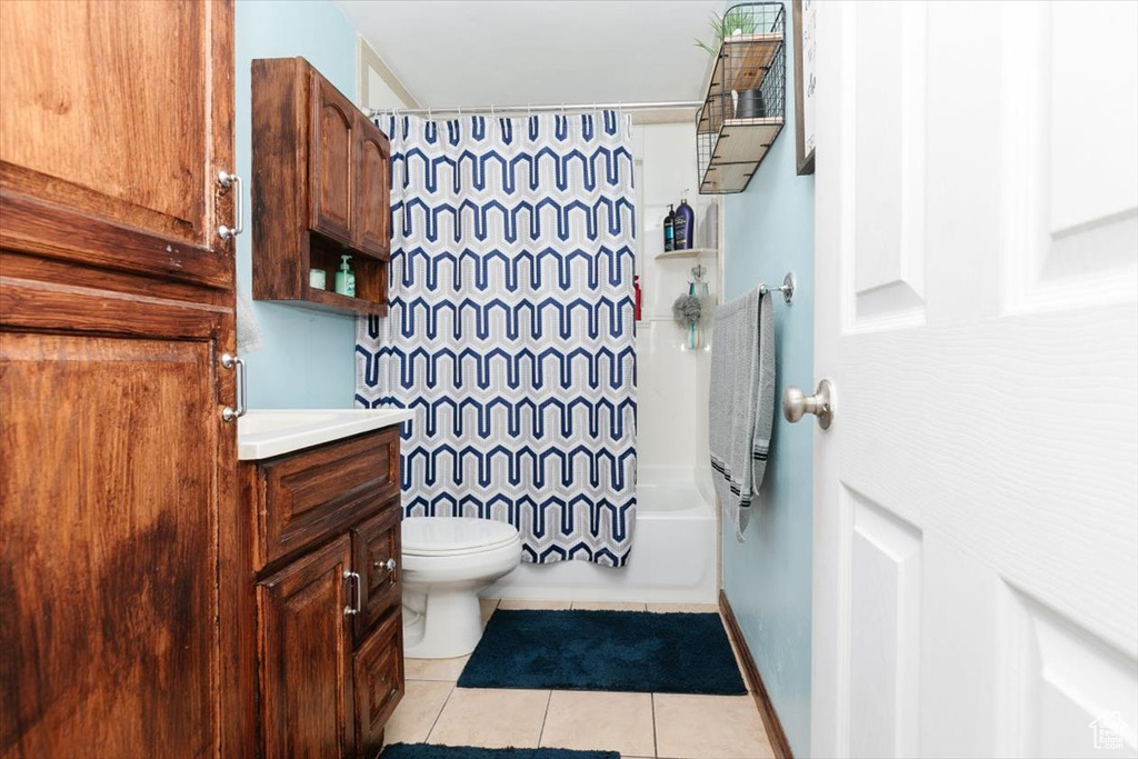 Full bathroom featuring vanity, tile patterned flooring, and shower / tub combo