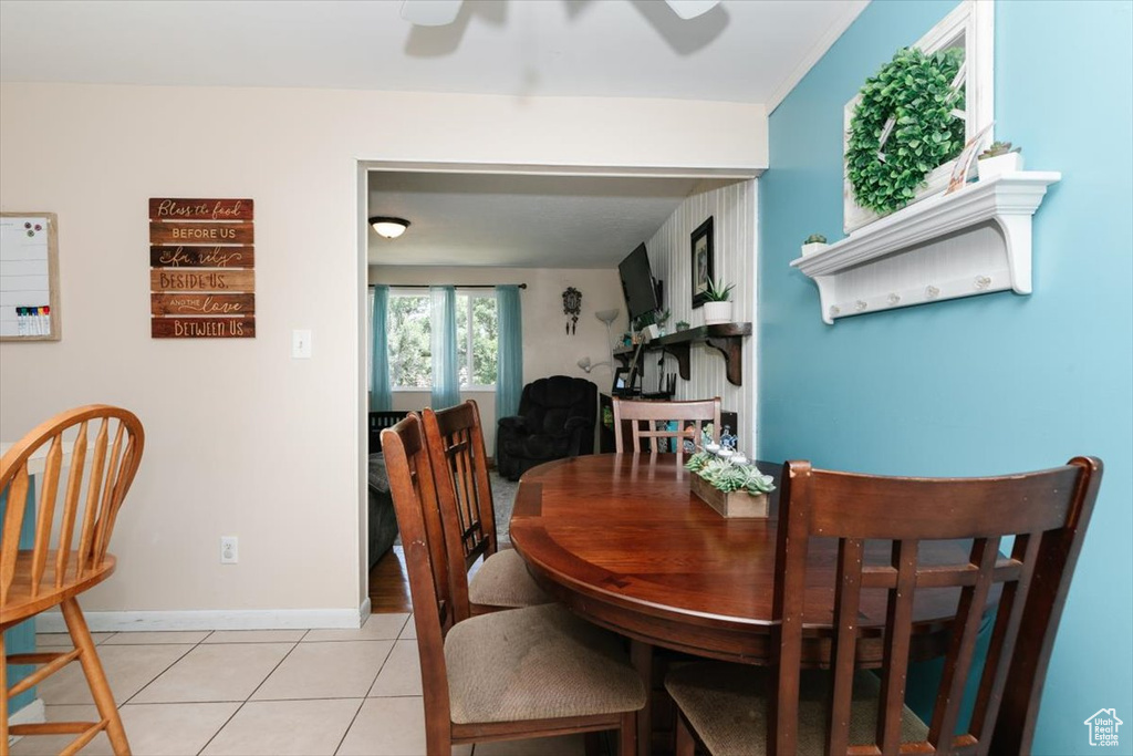 Dining space featuring ceiling fan and light tile patterned flooring