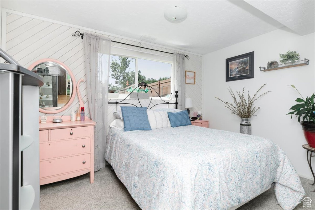 Bedroom with light carpet and access to outside