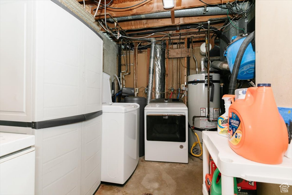 Laundry area with washing machine and clothes dryer and secured water heater