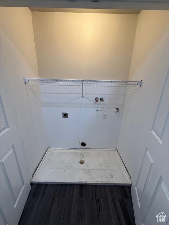 Laundry room with electric dryer hookup, hookup for a washing machine, and wood finished floors