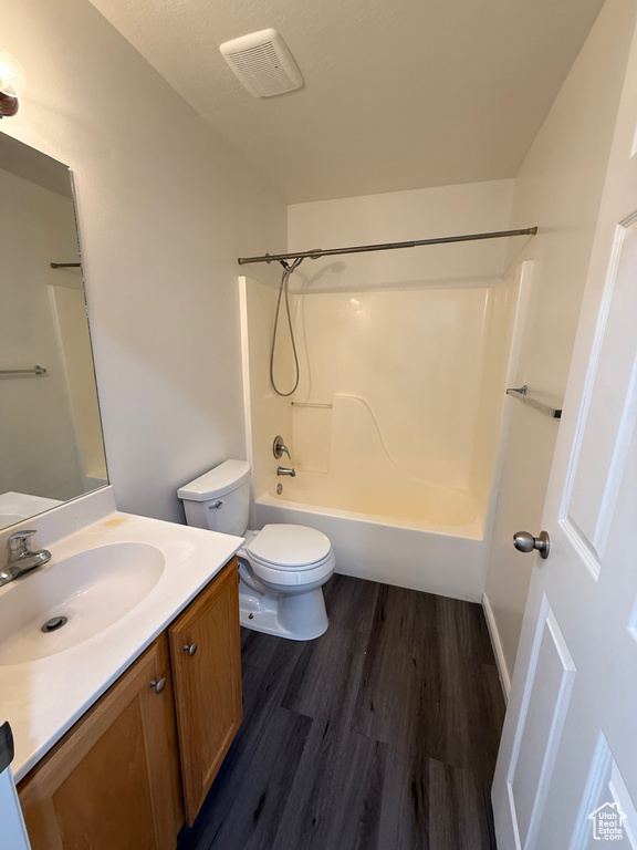 Bathroom featuring vanity, wood finished floors, and shower / bathtub combination