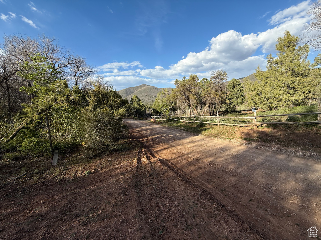 View of dirt / gravel road featuring a mountain view and a rural view