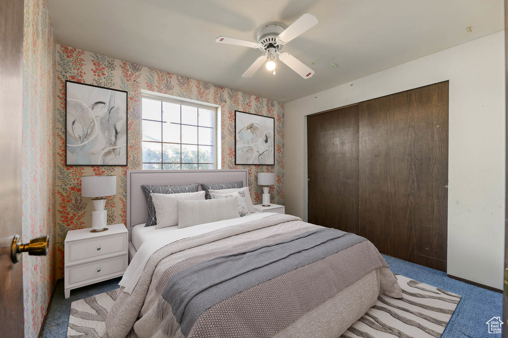 Carpeted bedroom featuring a closet, wallpapered walls, and a ceiling fan