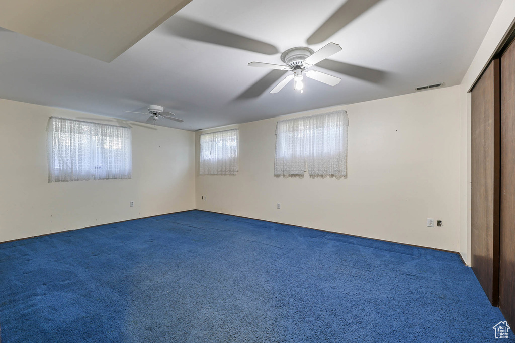 Unfurnished room featuring a ceiling fan and carpet flooring