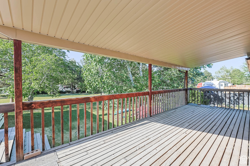 Wooden deck featuring a lawn