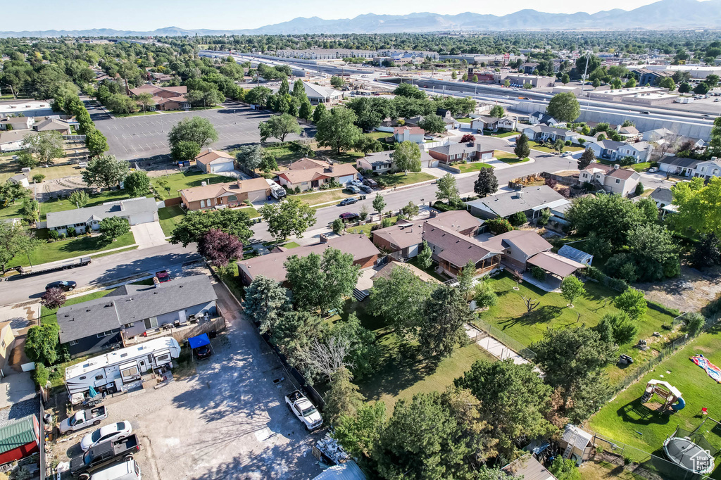 Aerial view of property\'s location featuring a mountain backdrop and nearby suburban area