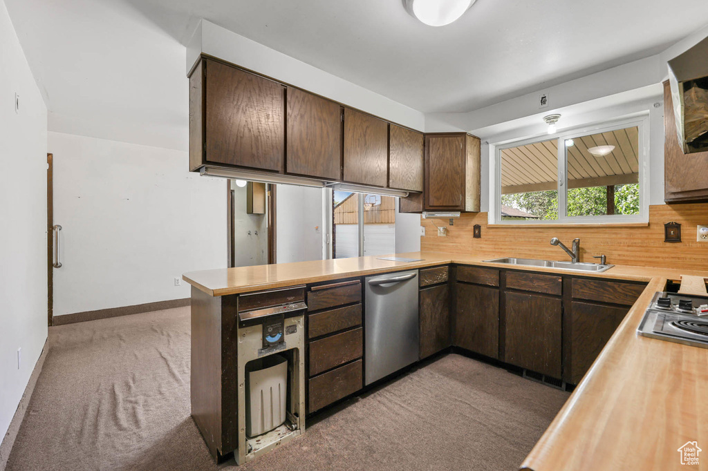Kitchen featuring stainless steel appliances, light carpet, and light countertops