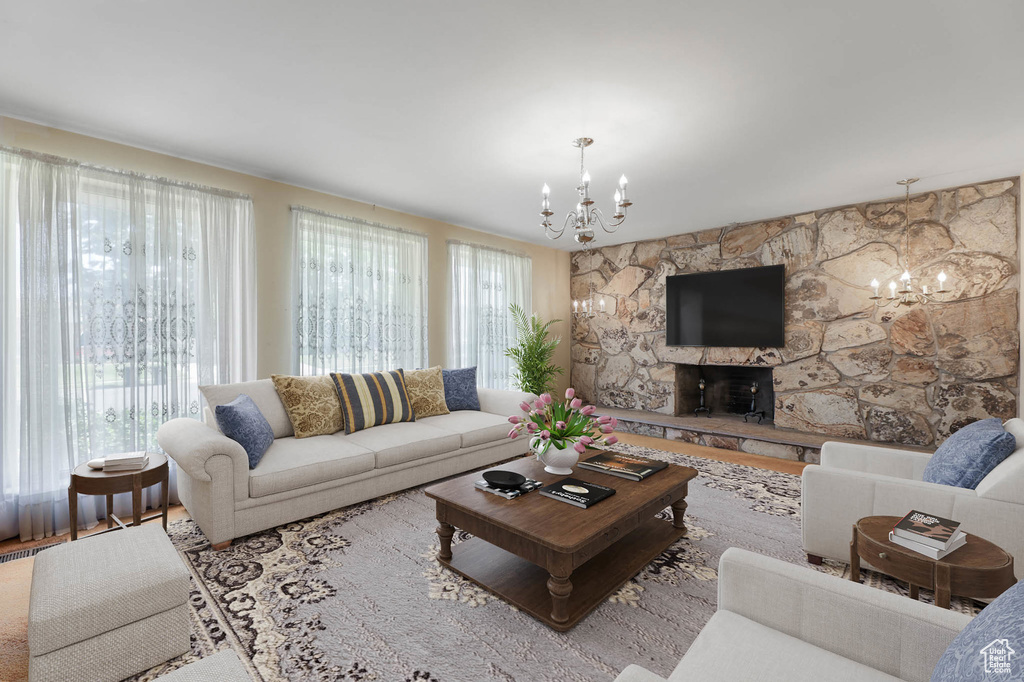 Living room featuring a chandelier, wood finished floors, and a fireplace